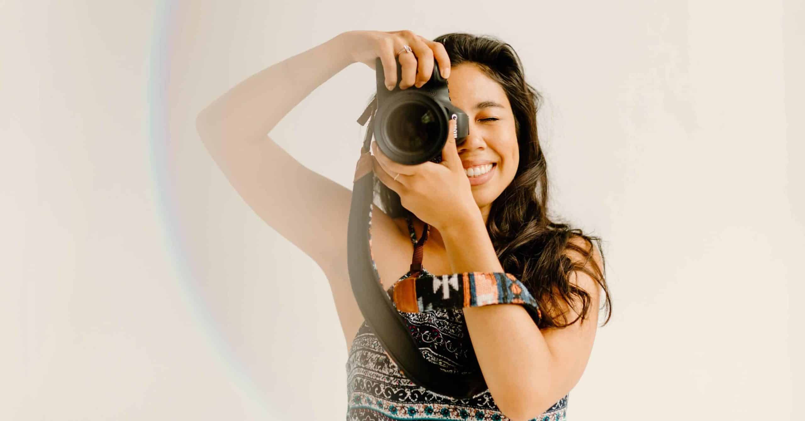 Adeline Nieto, brand photographer in NYC, holding her camera